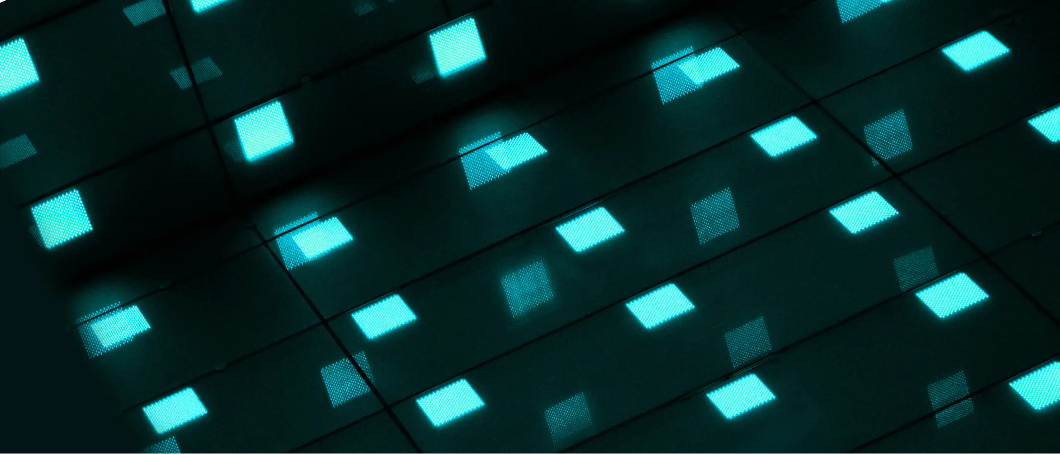 Blue glowing squares forming a geometric pattern on a dark surface.